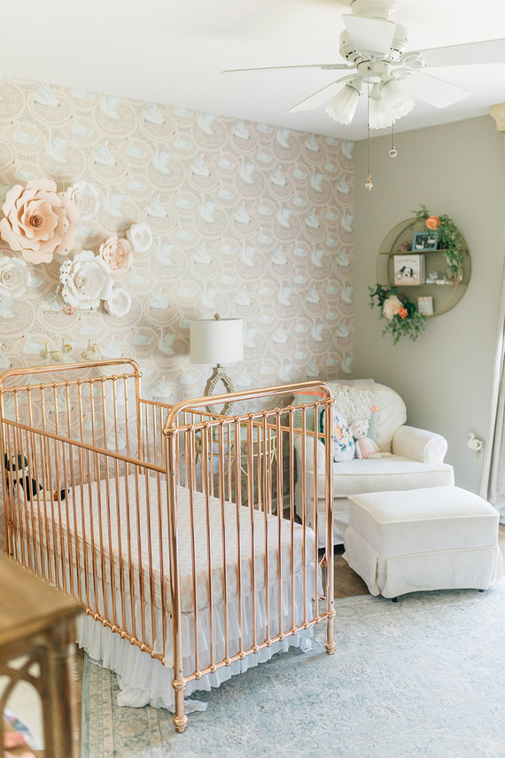 Vintage modern girl’s nursery with rose gold crib